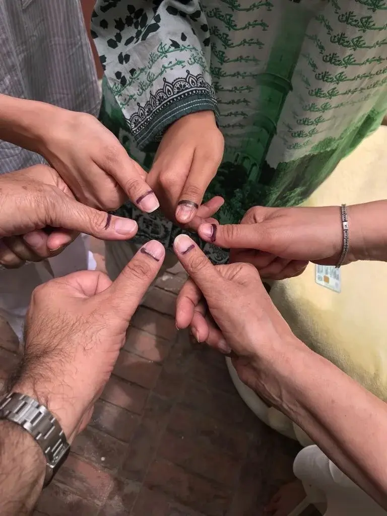 Voting with my family in Pakistan's 2018 elections; the indelible ink on our thumbs prevent double voting in elections